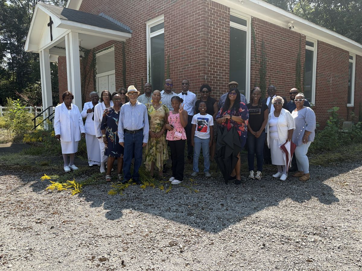 Flint River members of all ages gathered in front of the red brick church building